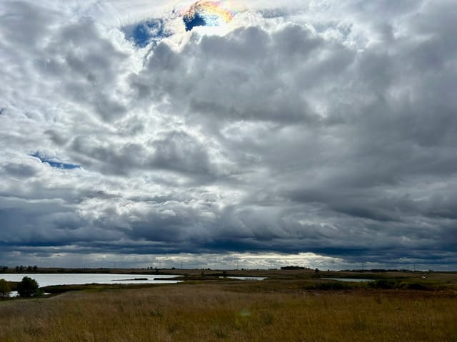 Early spring clouds fill the sky over a prairie .