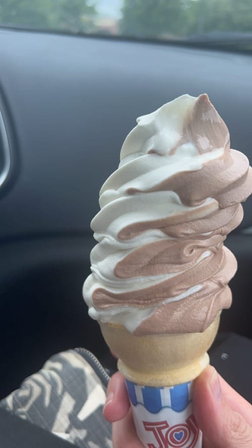 Woman holds a twist cone. 