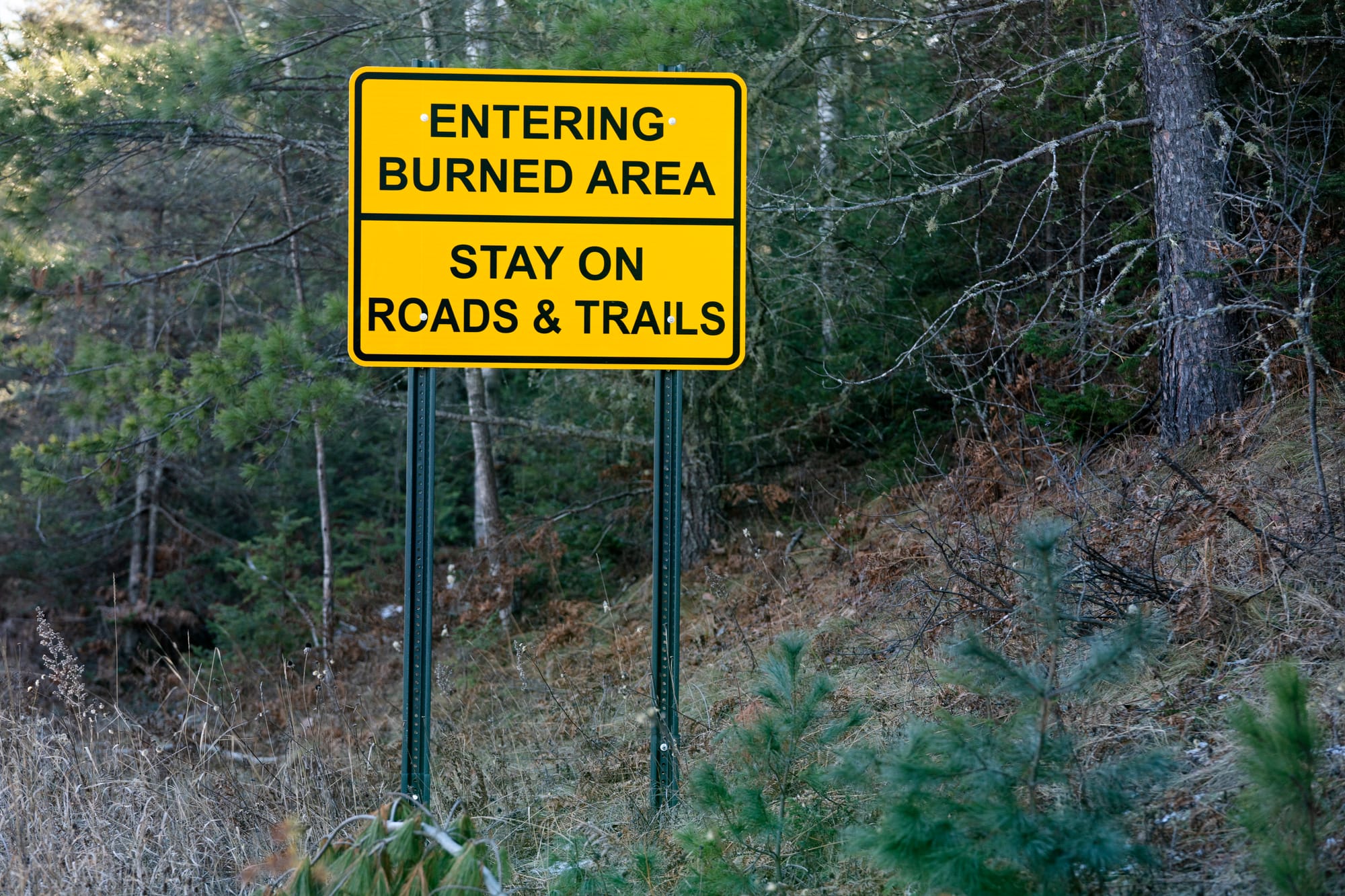 Sign warns visitors to stay on roads and trails