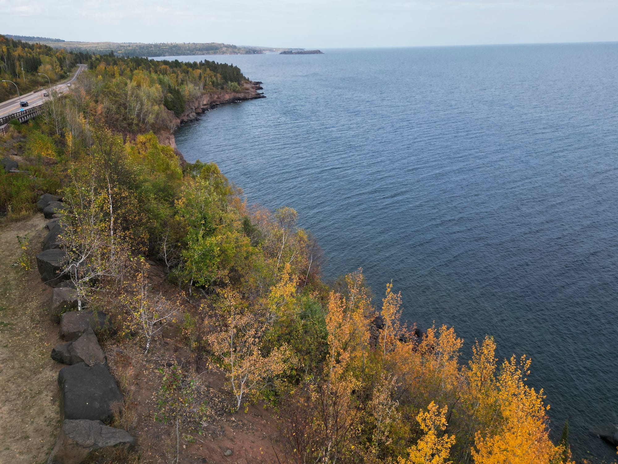 Bright yellow and orange leaves are seen near the Silver Creek Cliff Tunnel scenic overlook along Lake Superior.