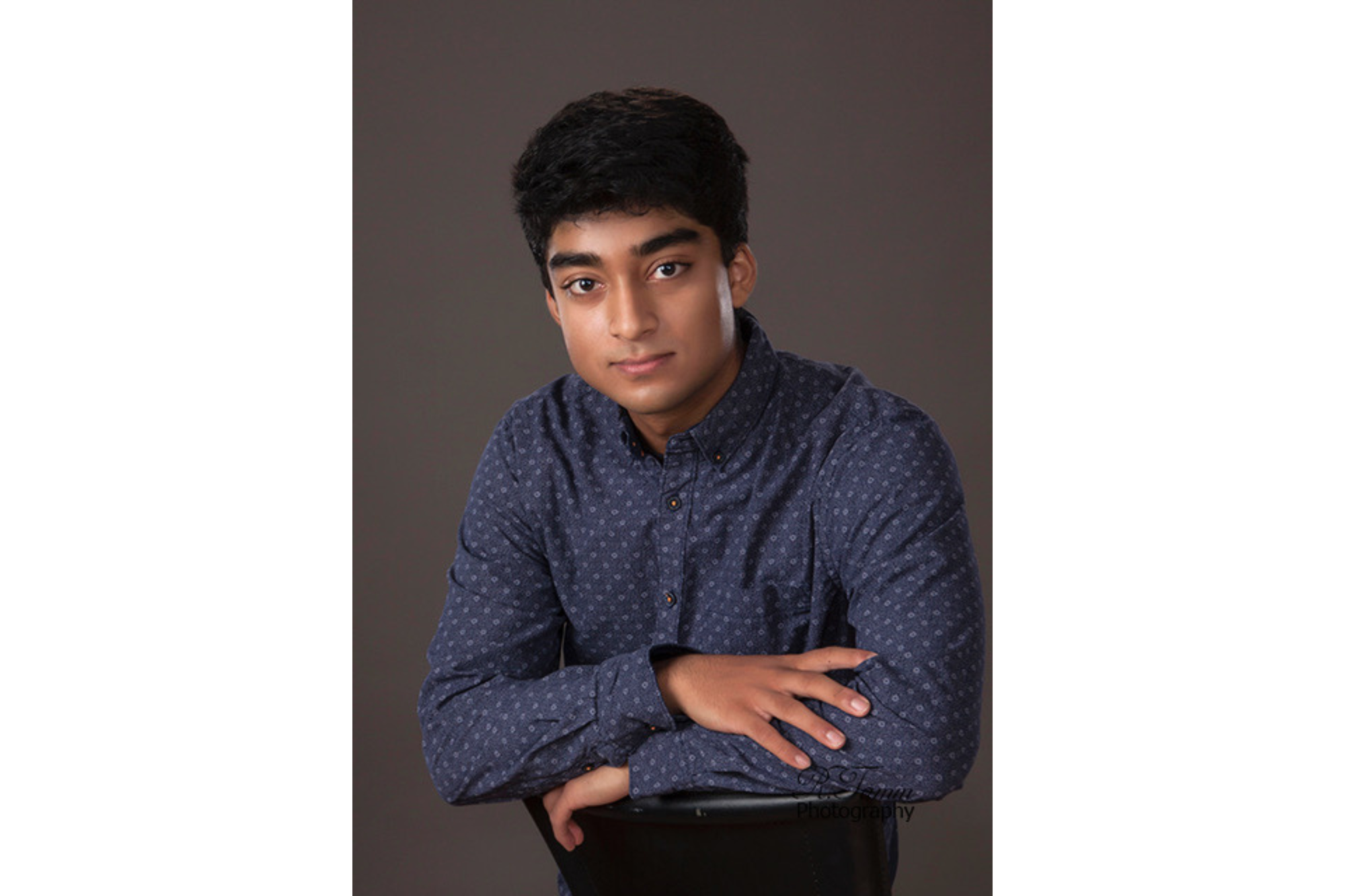 A young man poses for a portrait. 