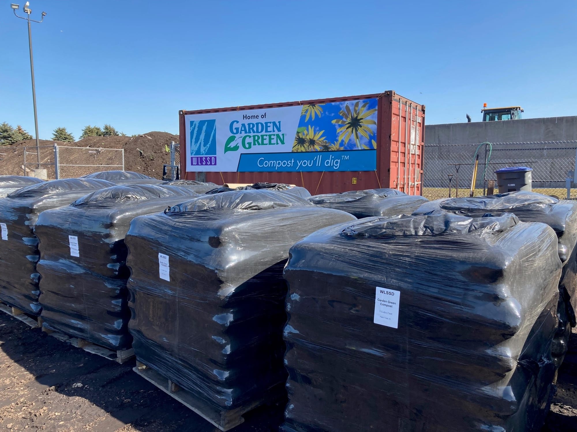 Bags of composts sit on pallets. 