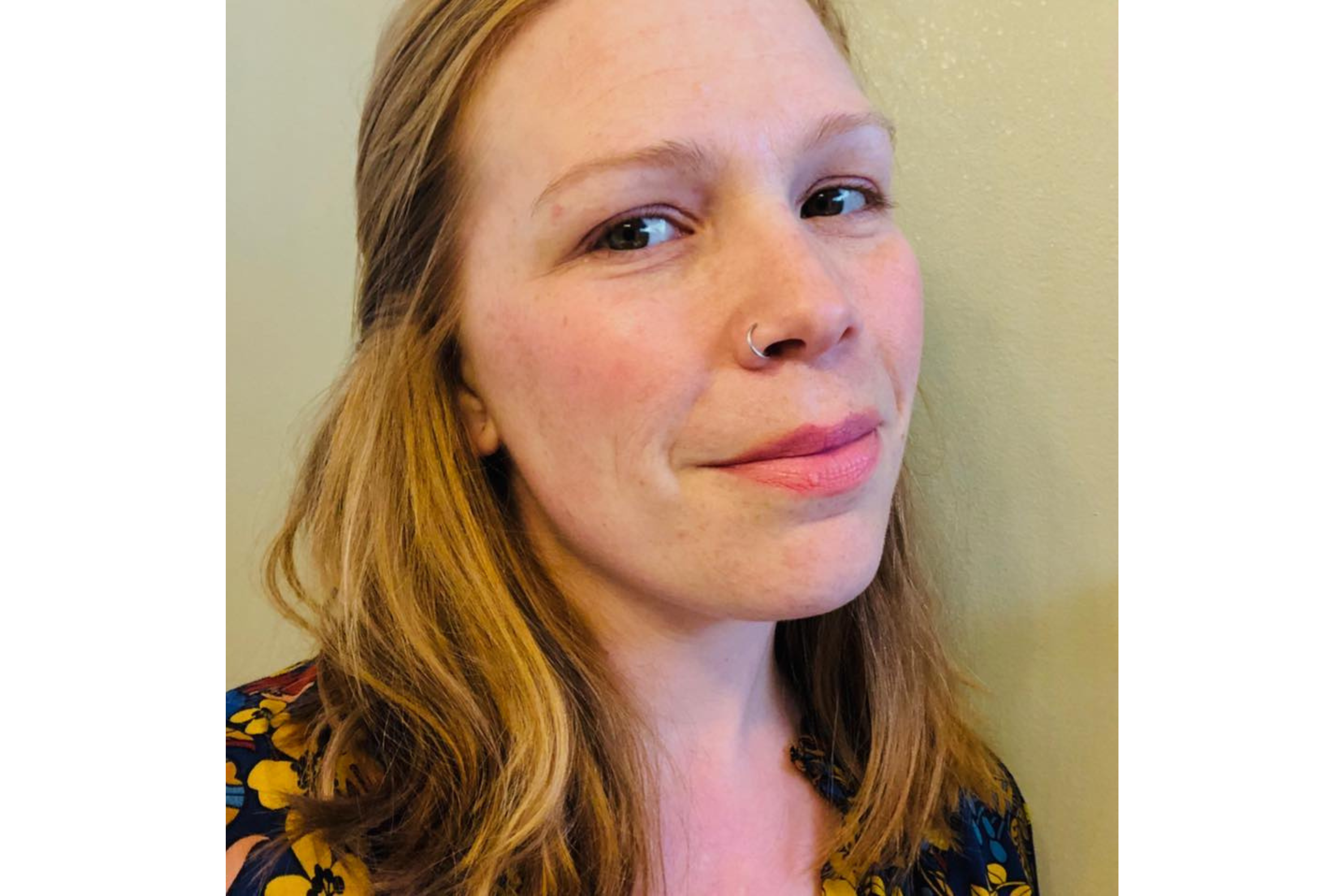 Woman smiles as she poses for a photo. 