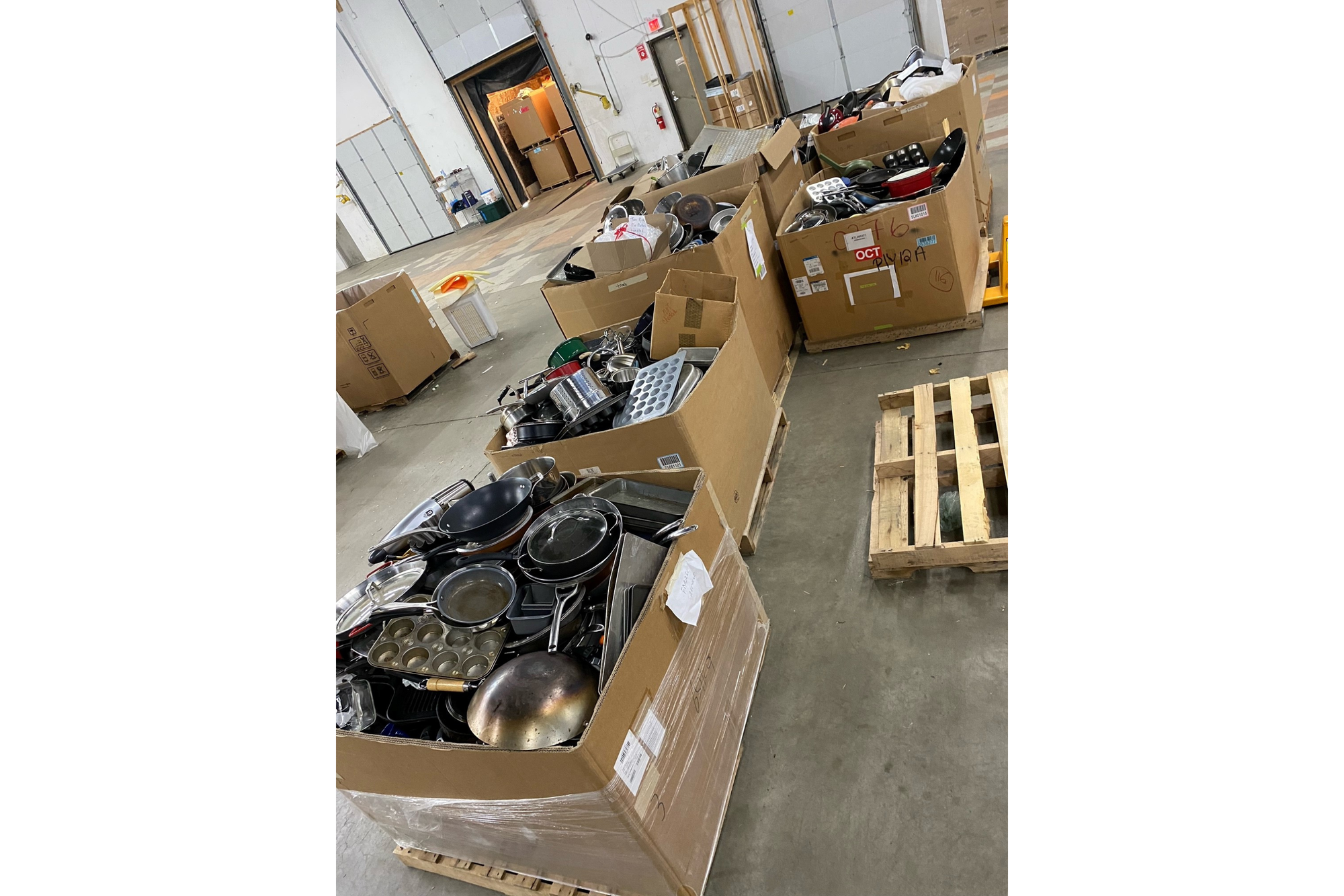 Six gaylord boxes of cookware are pictured. The cookware was donated by Ridwell members during a featured category campaign.