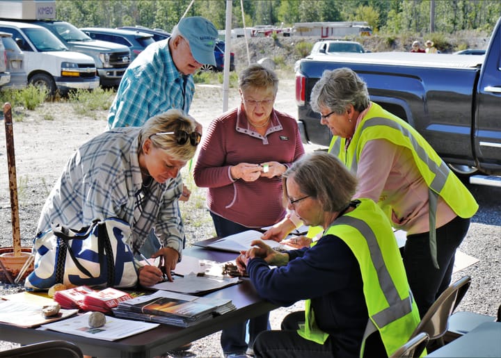 Four women and one man gather around a table to work on wildfire preparedness plans.