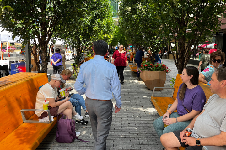 People walk in a crowded downtown area. 