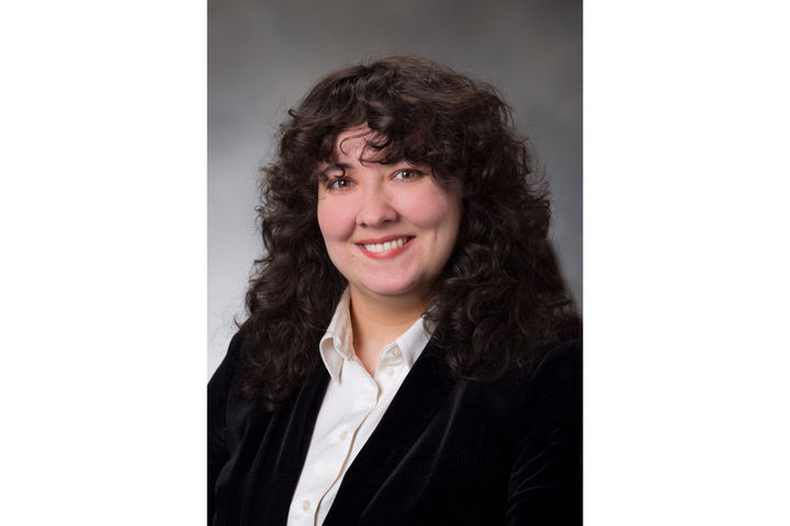 Woman poses for a professional portrait. 