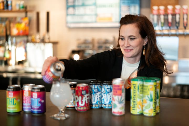 Woman pours a THC-infused drink into a glass. 